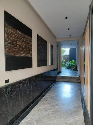 an empty hallway of a house with black marble floors at BeauLiving Park in Casablanca