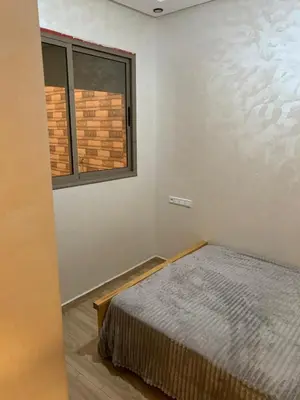a bedroom with a bed and a window at Bouznika in Bouznika