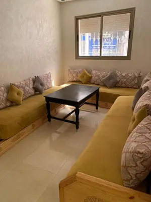 a living room with a couch and a coffee table at Bouznika in Bouznika