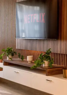 a television on a wall with plants on it at Elegance - 2 bedrooms with Pool - 5 min Airport in Nouaseur
