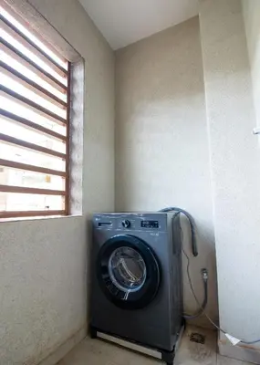 a washing machine in a room with a window at Elegance - 2 bedrooms with Pool - 5 min Airport in Nouaseur