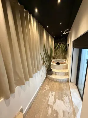 a hallway with bamboo blinds and a plant on the wall at Luxurious studio with Jacuzzi in Casablanca in Casablanca