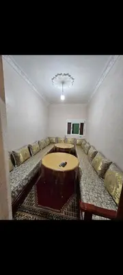 a living room with a couch and a table at Targuist in Settat