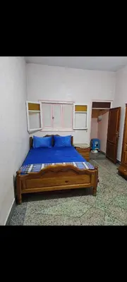 a bed with blue pillows in a bedroom at Targuist in Settat