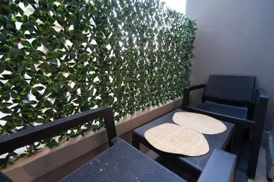two chairs and a bench next to a plant at Luxury Studio near to hassan 2 in Casablanca