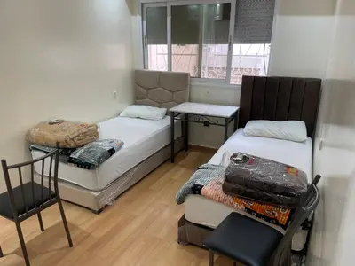 a small room with two beds and a window at Casablanca B& in Casablanca