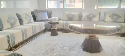a living room with a couch and a table at Appartement près de la corniche in Casablanca