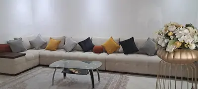a couch with many pillows in a living room at Appartement près de la corniche in Casablanca