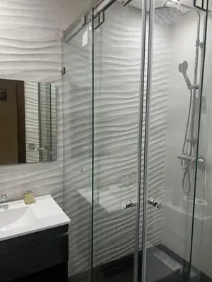 a bathroom with a glass shower and a sink at Love appartement1 in Casablanca