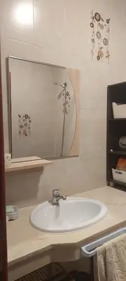 a bathroom with a sink and a mirror at Lina Cozy City Apartment in Casablanca