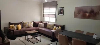 a living room with a couch and a table at Lina Cozy City Apartment in Casablanca