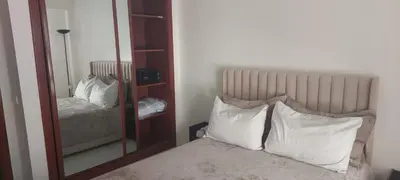 a bedroom with a mirror and a bed with white pillows at Lina Cozy City Apartment in Casablanca