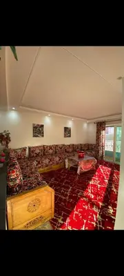 a large living room with a couch and a table at Appartement meublé à louer in Rabat