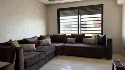 a brown couch in a living room with a window at Good vibes in Casablanca