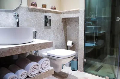 a bathroom with a sink and a toilet and a shower at Luxury 3 Suites - Av Annakhil - 5 Min to Stadium in Rabat