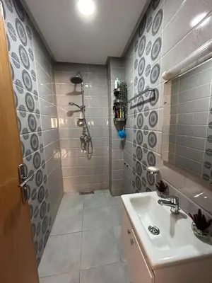 a bathroom with a sink and a shower at Skhirat apartment in Skhirat