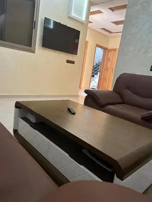 a living room with a couch and a table at Skhirat apartment in Skhirat
