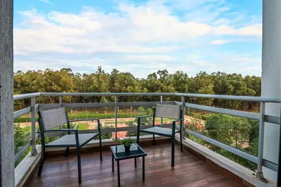 a balcony with two chairs and a table at Forest View -3 Bedroom Apartment - Near Airport in Nouaseur