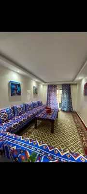 a living room with a couch and a table at Appartement à louer in Rabat