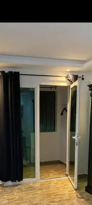 an empty room with a door and a mirror at Appartement à louer in Rabat