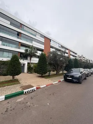a car parked in a parking lot in front of a building at Luxurious Apartment in Hay Riad in Rabat