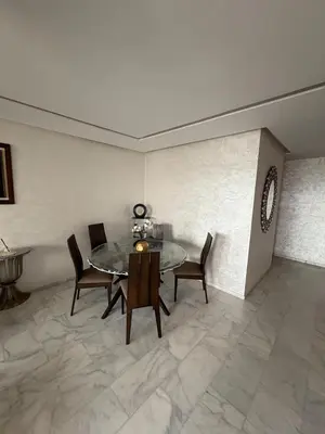 a dining room with a table and chairs at Luxurious Apartment in Hay Riad in Rabat