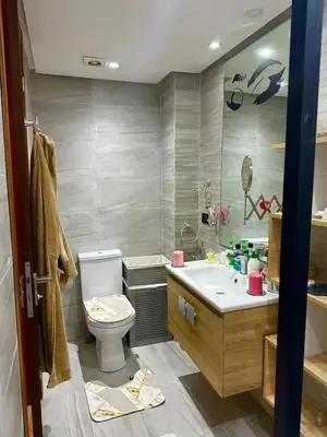 a bathroom with a toilet and a sink at Appartement meublé à louer à dar bouazza in Tamaris