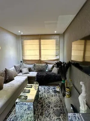 a living room with a couch and a table at Appartement meublé à louer à dar bouazza in Tamaris