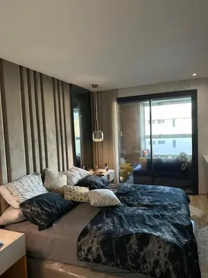 a bedroom with two beds with pillows on them at luxury furnished apartment for rent in Tamaris