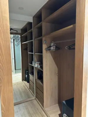 a closet with wooden shelves in a room at luxury furnished apartment for rent in Tamaris
