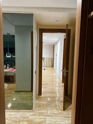 an empty room with a hallway leading to a kitchen at luxury furnished apartment for rent in Tamaris