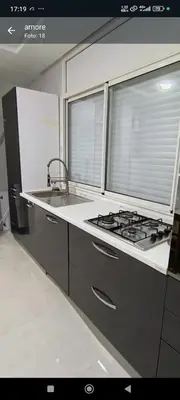 a kitchen with a stove and a sink and a window at Wifak temara in Temara
