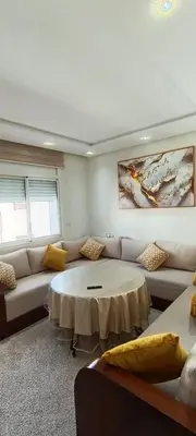 a living room with a couch and a table at Wifak temara in Temara