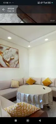 a living room with a table and a couch at Wifak temara in Temara