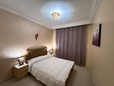 a bedroom with a bed and a kite on the ceiling at Agdal Central Spacious 2BR with Terrace in Rabat