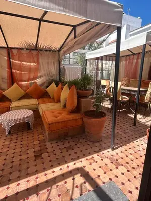 a living room with a couch under a tent at Duplex océan harhoura avec une grande terrasse in Temara