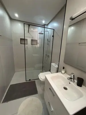 a bathroom with a shower and a sink and a toilet at Duplex océan harhoura avec une grande terrasse in Temara
