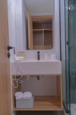 a bathroom with a white sink and a mirror at AnfaSuites - Résidence Pashmina - Maarif - Parking in Maarif