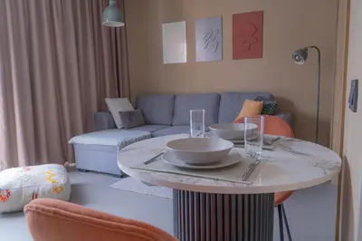 a living room with a table and a couch at AnfaSuites - Résidence Pashmina - Maarif - Parking in Maarif
