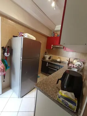 a kitchen with a refrigerator and a counter top at Summer & family apartments, Cheer on your team CAN in Mohammedia