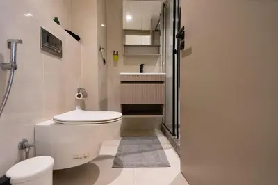 a white bathroom with a toilet and a sink at Luxury Studio Corniche near H2 Area in Casablanca