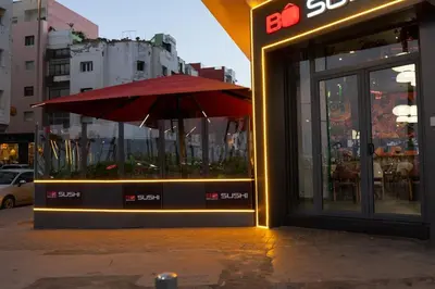 a store with a red umbrella outside of it at Luxury Studio Corniche near H2 Area in Casablanca