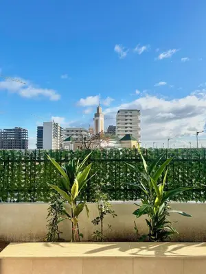 a view of a city skyline with palm trees at Zen Terrace Design Studio in Zenata, WiFi & Pool in Aïn Harrouda
