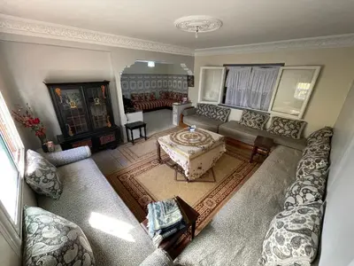 an aerial view of a living room with couches at Appartement a louer par jours in Temara