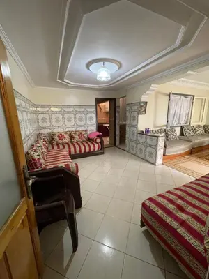 a living room with couches and a couch at Appartement a louer par jours in Temara