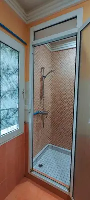 a shower stall in a bathroom with a window at \u9526\u9ca4JinLi 28villa in Casablanca