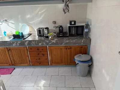a kitchen with a counter with a sink and a microwave at Spacious apartment in Agdal, close to everything in Rabat