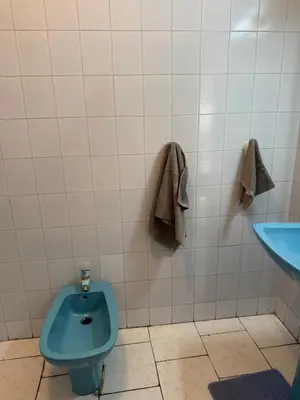 a bathroom with a blue toilet and a sink at Spacious apartment in Agdal, close to everything in Rabat