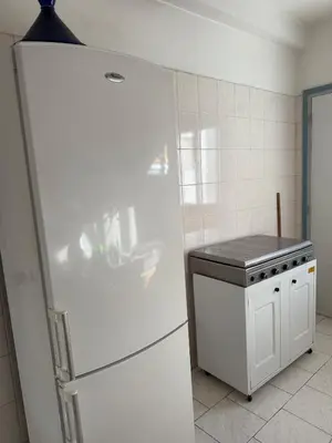 a kitchen with a white refrigerator and a stove at Spacious apartment in Agdal, close to everything in Rabat