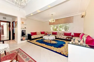 a living room with a couch and a table at Appartement chic de 2 chambres au coeur de casablanca in Casablanca